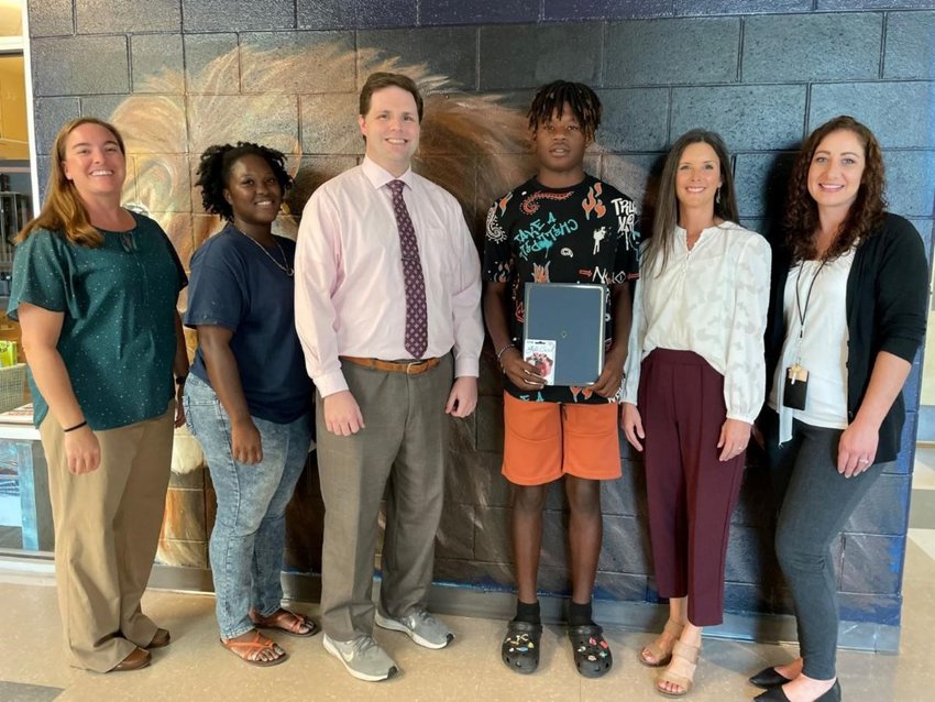 Foley Middle School student Cam'Ron Page (center, holding certificate) is pictured with Principal Ashley McNair, mother Roneka Page, FOX 10 TV's Michael White, Baldwin EMC representative Kim Frank and teacher Tracy Brooks.