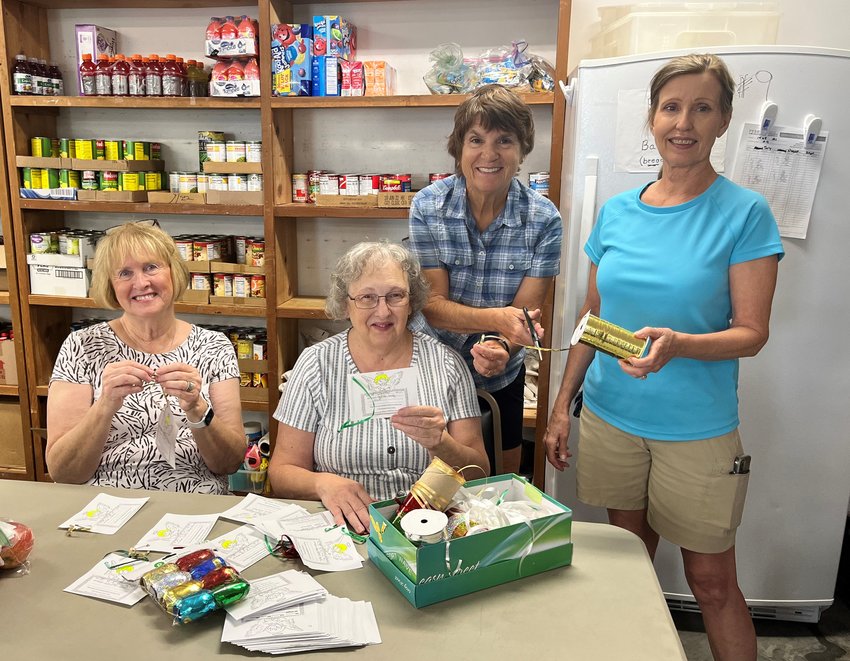 Volunteers (from left) Marinda Barbaree, Kay Knitter, Alice Greenwald, and Mary Claire Dover make angels that will be filled with the kids' wishes. The cards will be taken to area businesses, churches, and restaurants. Please pick up an angel and help make an area child's Christmas the best it can be.