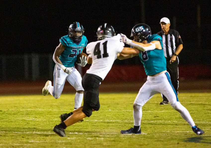 Gulf Shores senior JR Gardner sets up a block from Nick Carris on the outside during a first-half run in the Dolphins&rsquo; Class 5A Region 1 game against the Elberta Warriors at the Sportsplex Oct. 6. Gulf Shores set program records for the nine regular-season games it won and the 402 points it scored.