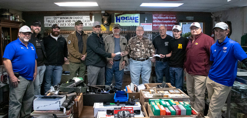 The Gulf Coast Gun Collectors Association presented donation checks to sport shooting teams from Orange Beach and Robertsdale High School Wednesday, Nov. 16, at Greener Fields Firearm and GunSmithing in Foley. Pictured from left to right are Chris Litton, Tim Harry and Drew Hemby from Orange Beach, GCGCA Activities Chairman Medrick Northrop, Orange Beach&rsquo;s Matt Parker, GCGCA Vice President Frank Snarr, President Howard Smith and Secretary Mark Parden, Robertsdale&rsquo;s Earl Fitkin and John Manning, as well as Orange Beach&rsquo;s Clint Miller.
