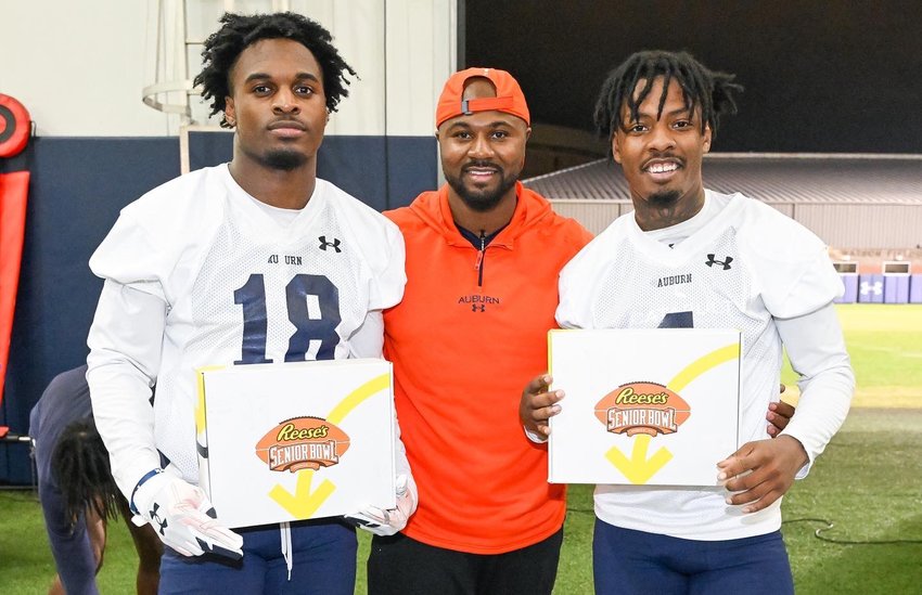 Spanish Fort grad DJ James (4) poses with Auburn secondary coach Zac Etheridge and Nehemiah Pritchett (18) after the pair of defensive backs were invited to the Senior Bowl. They were two of five Tigers surprised with the invitation after practice Thursday, Nov. 10.