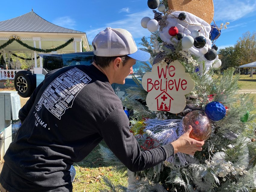 Jayson Kimbrough, co-owner of Walker Hometown Animal Care and Foley&rsquo;s reigning Christmas Tree Decorating Contest champion is puts the final touches on this year&rsquo;s tree.