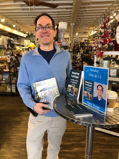 Local historian Alan Samry poses with his latest book, &ldquo;Mapping Fairhope: Legends, Locals, &amp; Landmarks&quot; at Page &amp; Palette in downtown Fairhope where it is available for purchase.