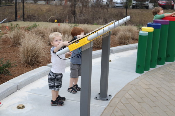Children play on xylophones placed at the new Foley Pine Street Park. The park, next to Foley Middle School, was dedicated Wednesday, Jan. 11.