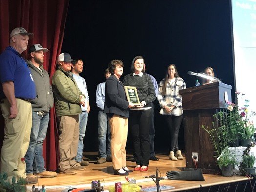 A delegation from Wauchula, Florida, presents a plaque to Fairhope Mayor Sherry Sullivan and city utility workers recognizing the work done by Fairhope crews to repair storm damage in Wauchula after Hurricane Ian struck the Florida community in 2022.