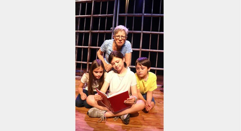 Diane Irwin hovers behind over the students of Crunchem Hall in Exit Stage Left's upcoming production of &quot;Matilda&quot; in Foley this weekend. From left to right are Karis Sherman, as Lavender, Anna-Frances Roberson, as Matilda, and Jonah Schrader as Bruce.