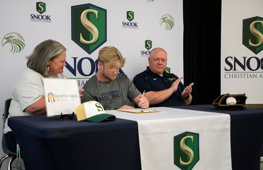 Snook Christian senior Philip Butts puts pen to paper to seal his commitment to the Brewton-Parker baseball program during a signing ceremony Wednesday, May 3, at the school. Butts and the Eagles swept their first-round playoff series earlier this postseason.