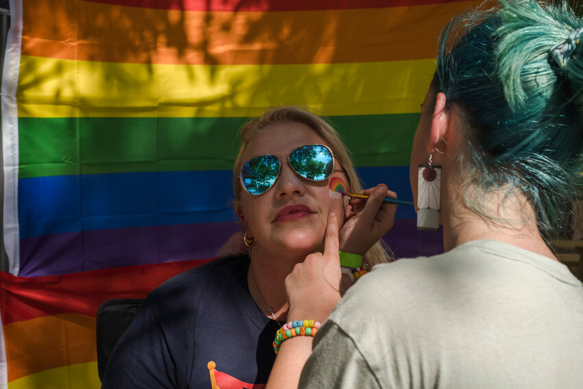 Erin Allison gets a rainbow painted on her face by her step daughter, Rylie Allison at Color Fairhope with Pride event in 2022.