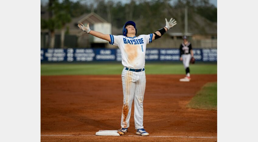 Bayside Academy senior Josh Gunther pulls into third base and celebrates a triple with the Admiral bench during the first day of the Prep Baseball Report South Alabama Showdown Feb. 23 at the Gulf Shores Sportsplex. The Wake Forest signee was recently named the Baldwin County pitcher of the year by Mobile Baseball Connection.