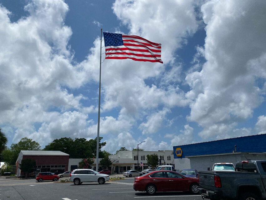 A new giant American flag snaps in the wind in downtown Foley. The new nylon flag replaces a heavier cotton banner and should be more noticeable in lighter breezes.