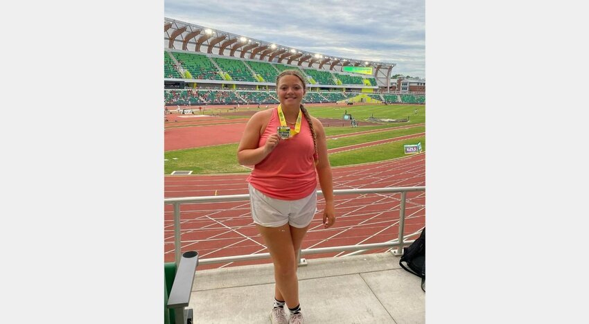 Recent Foley High School graduate Emily Wolf shows off the bronze medal she earned in the discus event of the Nike Outdoor Nationals at Hayward Field in Oregon Friday, June 16.