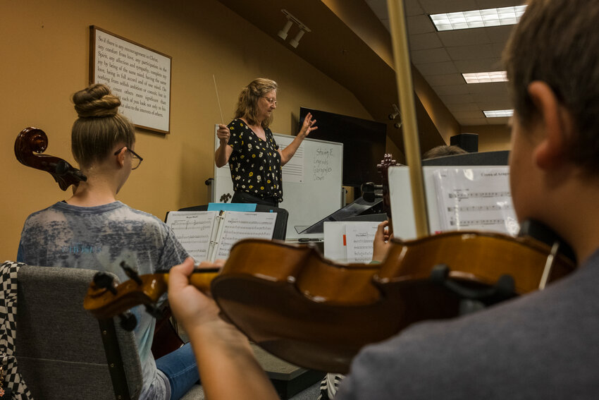 Cori White, strings instructor, leads a tune.