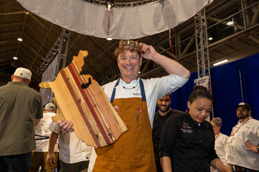 Chef Brody Olive wears his crown at the Great American Seafood Cook-Off in New Orleans, Louisiana, on Saturday, Aug. 5.
