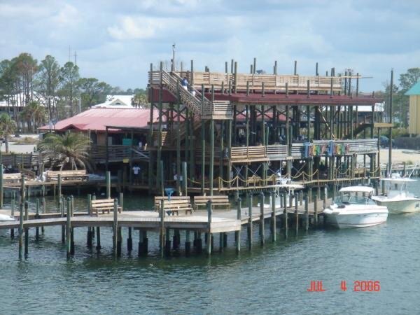 Tacky Jacks in 2006. Hurricane Ivan was the first big hit, but the rebuild increased the deck size. Hurricane Sally carried away the docks, which have been rebuilt, and wreaked havoc on the gift shop.