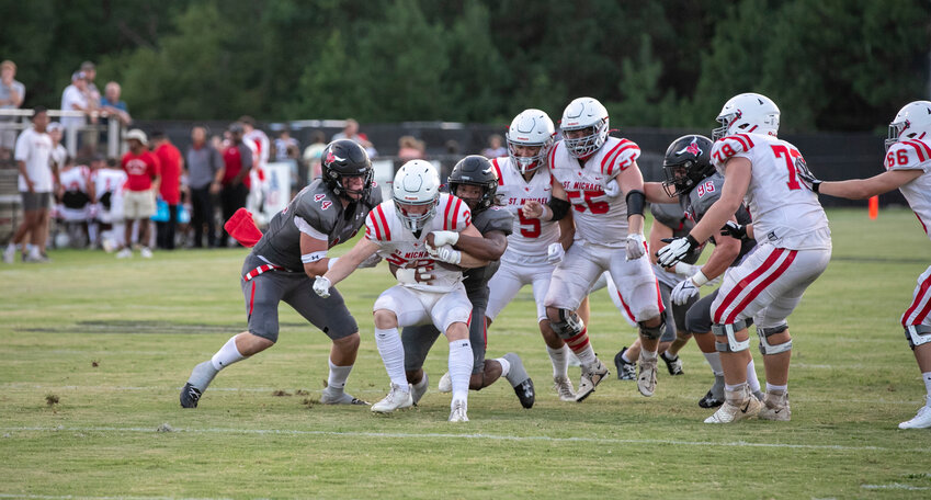 Spanish Fort&rsquo;s Cole McConathy (44) and Sterling Dixon (10) take down St. Michael&rsquo;s Martin Corte (22) on a run attempt during Thursday&rsquo;s preseason jamboree in Spanish Fort. The Toros led 10-6 when varsity players came off the field at halftime.