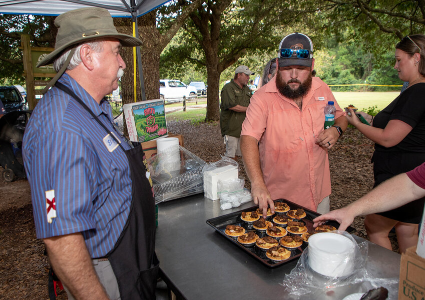 Steve LeMay watches as the winning Chandler Mountain tomato pie with blackened quail dish is sampled at the AWF Wild Game Cook-Off Finals in Millbrook.