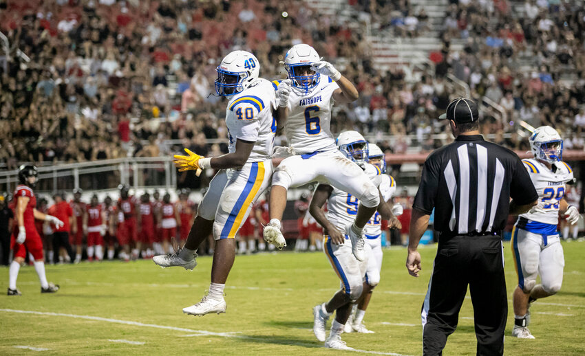 Fairhope&rsquo;s PJ Harbin (40) and Desmond Thomas (6) celebrate Dixon Davis&rsquo; fumble recovery in the third quarter of Thursday&rsquo;s season-opening contest between the Pirates and Spanish Fort Toros. Thomas broke off a 64-yard rushing touchdown in the final four minutes of regulation to help lift Fairhope.