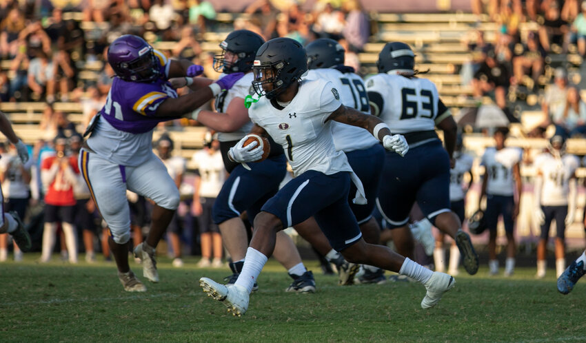 Foley&rsquo;s Perry Thompson looks for running room on a carry during the Lions&rsquo; spring game against the Daphne Trojans at Jubilee Stadium on May 19. Thompson and the Foley Lions opened the regular season with a 45-19 win over Prattville where Thompson threw for one touchdown and ran for another.