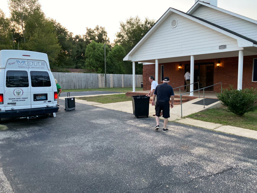 Poll workers leave the New Fellowship Church on Tuesday after Mills Community residents voted 43-17 to have their community become part of the city of Foley