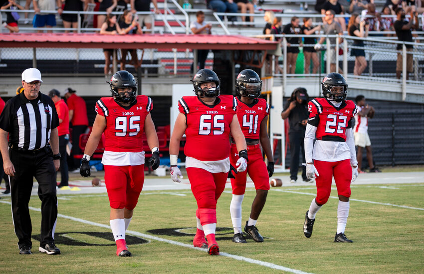 Spanish Fort&rsquo;s Grey Freeman (95), Bree Blackmon (65), Jiraiya King (41) and Aarion Riley (22) walk out for the coin toss ahead of the Toros&rsquo; regular-season opener against the Fairhope Pirates at home on Friday, Aug. 25. Spanish Fort is set to open play within Class 6A Region 1 against the Blount Leopards this Friday back on The Hill.