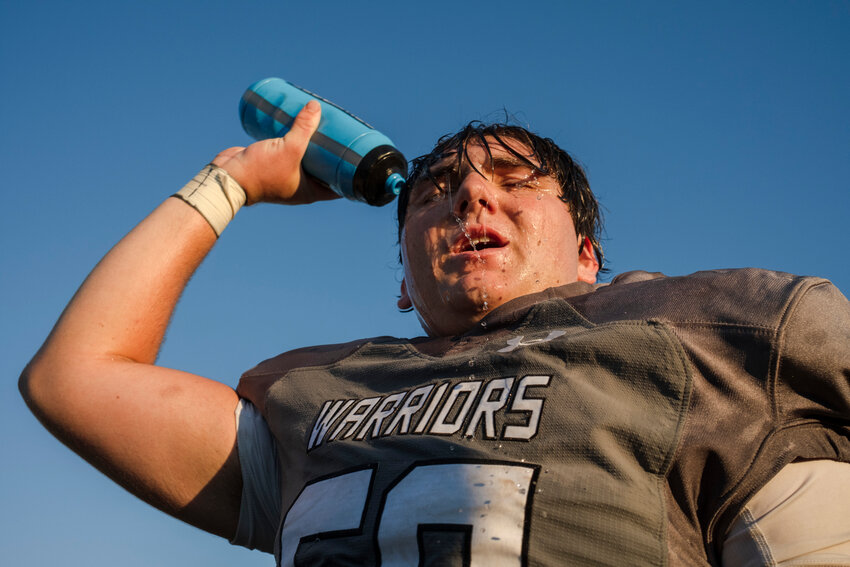 Elberta senior Aiden Freemantle dumps water on his head during the Warriors&rsquo; preseason jamboree against the Robertsdale Golden Bears on Aug. 17. The Alabama Cooperative Extension System has tips on how athletes can stay hydrated through the late-summer heat.
