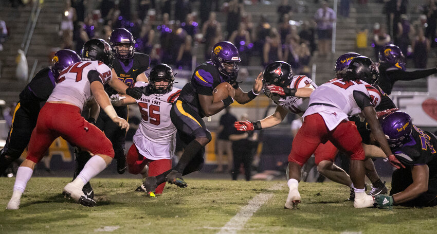 Spanish Fort junior linebacker Bishop Burkhalter (4) and the Toro defense &mdash; including junior Newton Gardner (24) and seniors Grey Freeman (55) and Caleb Thomas (35) &mdash; corrals Daphne junior quarterback Jamar Malone (9) in the backfield during the second half of rivalry action at Jubilee Stadium on Friday, Sept. 29. Spanish Fort used a second-half shutout after the Trojans scored on all four first-half possessions to earn a 35-27 win.