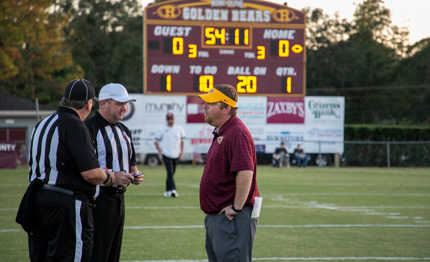 Robertsdale&rsquo;s Kyle Stanford meets with the officials before the Class 6A Region 1 game against Spanish Fort at JD Sellars Stadium on Oct. 14, 2022. In his fifth year at the helm of the Golden Bear program, Stanford was relieved of his head coaching duties on Tuesday, Oct. 10.