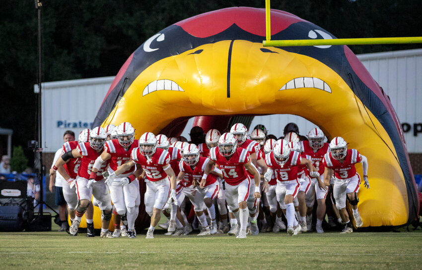 The St. Michael Cardinals emerge on W.C. Majors Field at Fairhope Municipal Stadium for Sept. 21&rsquo;s Class 4A Region 1 game against the Satsuma Gators. The Cardinals will be heading to the playoffs for the first time after they set a single-season scoring record Friday.