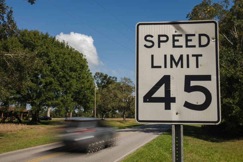 A car passes a speed limit sign on County Road 36 near Loxley earlier this week.