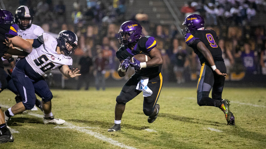 Daphne senior Nick Clark takes a carry around the edge during the third quarter of the Trojans&rsquo; Class 7A Region 1 battle against the Foley Lions at Jubilee Stadium on Friday, Oct. 27. Clark recorded three touchdowns in the first half to help Daphne earn a 57-35 win which locked in a No. 3 seed for the playoffs.