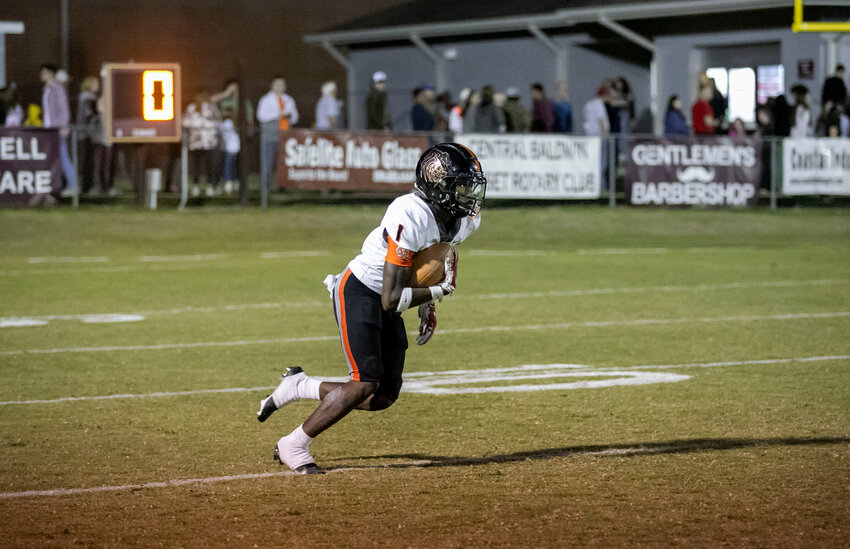 Baldwin County junior Ti Mims takes off on his 88-yard kickoff return for a touchdown just before halftime during the Tigers&rsquo; Class 6A Region 1 game against the Robertsdale Golden Bears on the road Friday night. Mims added a 41-yard touchdown catch and a 10-yard rushing score to help Baldwin County end the season with a 43-13 win over Robertsdale.