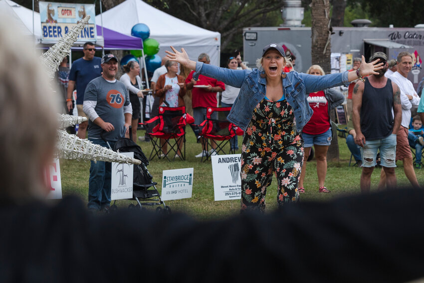 Ashley Valentine runs to celebrate with her mom, Jill, after winning the cheese toss contest at the 2022 Chocolate &amp; Cheese Festival at Heritage Park in Foley.