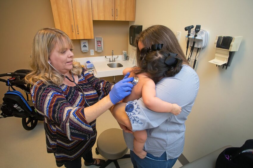 Dr. LaDonna Crews, associate professor of pediatrics and a pediatrician with USA Health Physicians Group, examines a patient Wednesday, Jan. 2, 2019 in the pediatric clinic at the Strada Patient Care Center.