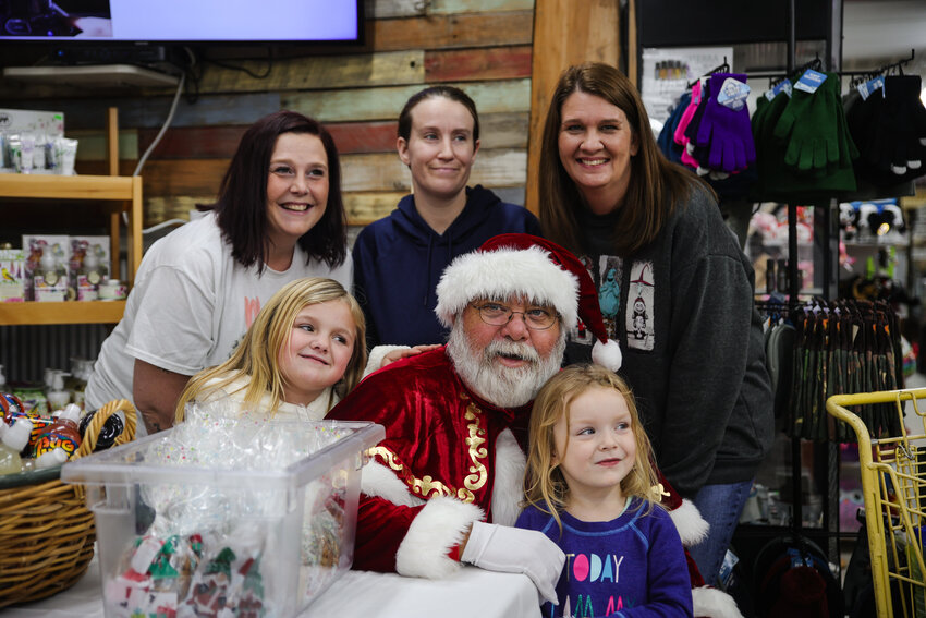 Santa Claus posing with volunteers at the Maw Maw's Country Market food drive on Dec. 10.