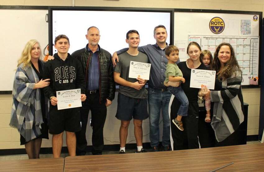 In this photo, cadets Landon Ward, Arthur Zamprogno and Grace Godwin (from left to right, holding certificates) pose with their families. Ward and Zamprogno are the primary selects, and Godwin is an alternate.