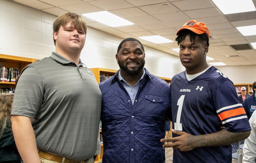Following Wednesday&rsquo;s Early Signing Day ceremony at Foley High School, Logan Joellenbeck, head coach Deric Scott and Perry Thompson pose for a picture. Joellenbeck cemented his commitment to South Alabama and Thompson sealed his pledge to Auburn.