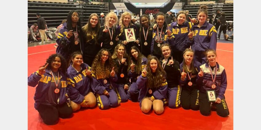 The Daphne Trojans pose with the team championship trophy for the third time in four years thanks to five top-two finishes and nine more podium finishes on Friday, Jan. 19, at the Birmingham Crossplex as part of the AHSAA girls&rsquo; wrestling state championships. Alanah Girard (100), Emily Smith (114) and Kalyse Hill (132) took home individual championships and McKenzie Nguyen (106) and Kimber Alford (145) earned silver medals as runners-up.
