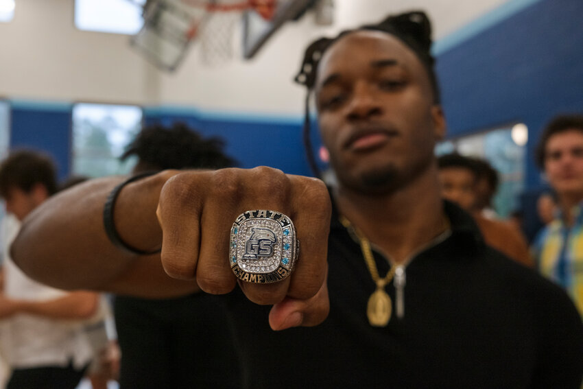 Gulf Shores senior Ronnie Royal shows off the Dolphins&rsquo; 2023 Class 5A state championship rings presented during a ceremony on Wednesday, April 10, at the high school. The state championship MVP and Class 5A Back of the Year said the ring was worth it for all the work they put in during the offseason.