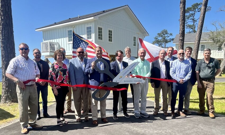 Officials cut the ceremonial ribbon for the new Lakeside Cabins at Gulf State Park on Monday, April 15, 2024