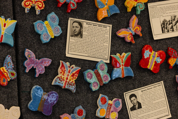 Ceramic butterflies made by students at Daphne High School that features an index card with the names of children who died during the Holocaust.