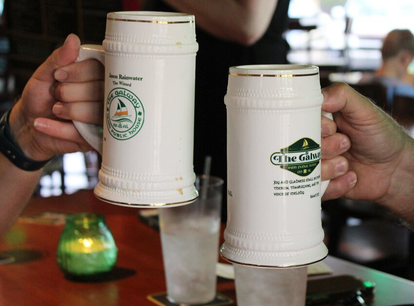 The Galway sold personalized mugs in April. The first 50 sold out quickly and now hang over the bar. Some of the mug owners visited their mugs for the first time during the soft opening.