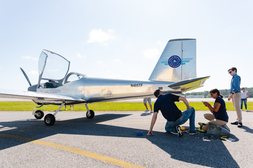 Haley Kellogg, Gulf Shores High School Aviation Instructor, working on the airplane before it takes flight on May 1.