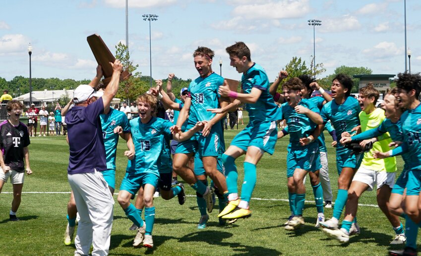 The Gulf Shores Dolphins celebrate their first-ever boys&rsquo; soccer state championship following a 3-2, overtime win against the Guntersville Wildcats on Friday, May 10, in Huntsville. Gulf Shores survived a weather delay in the Class 5A semifinals and had play suspended Wednesday evening before the Dolphins clinched a return trip to the championship match Thursday morning.