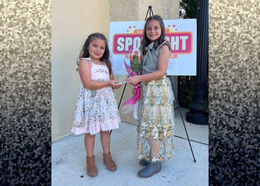 Essie Rae and Marcie Ann Vesely pose with their award after winning the Mini Division with their piano duet &quot;Popcorn, Please!&quot; at the Distinguished Young Women's Community Night program in Mobile last October.