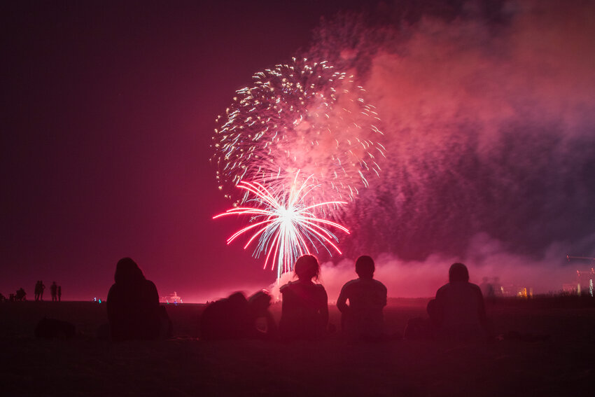 A group of people enjoy fireworks on the beach at Gulf State Park on July 4th, 2023.