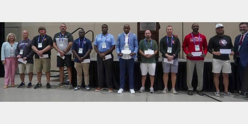 David Offerle from St. Michael Catholic (fifth from right) represented the Cardinals at the Principals & Athletic Directors meeting on Friday, July 19, in Montgomery. The Class 4A school in Fairhope was one of 10 to receive a $1,000 Sportsmanship Grant from the AHSADCA. Also pictured, from the left, are AHSAA Associate Executive Director Kim Vickers, Berry’s Danny Raines, Alexandria’s Zac Welch, B.B. Comer’s Adam Fossett, Paul Bryant’s Eric Hines, Murphy’s Edwin Burke, Greensboro’s Luther Riley, Offerle, G.W. Long’s David Watts, Loachapoka’s Albert Weeden and Sardis’ Josh Wallace.