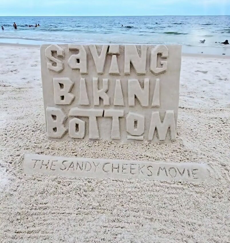 A poster-like sand sculpture of the new Spongebob movie's title created by Sand Castle University.