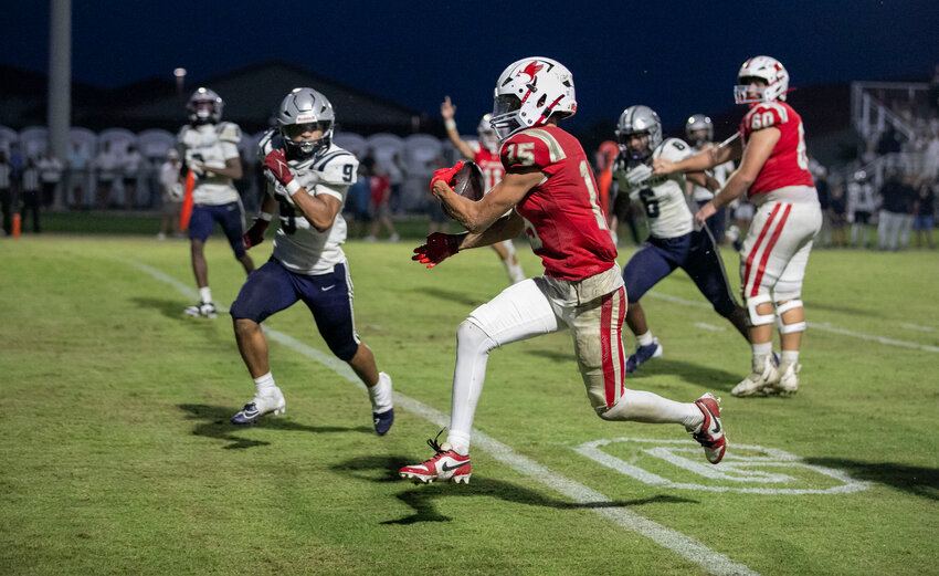 St. Michael junior receiver Tucker Tomlinson hits the goal line during his second-quarter touchdown reception from sophomore quarterback Gunner Rivers on Aug. 16 during a preseason jamboree against Alma-Bryant. Tomlinson&rsquo;s score helped the Cardinals debut their new on-campus stadium with a 30-0 win over the Class 7A Hurricanes.