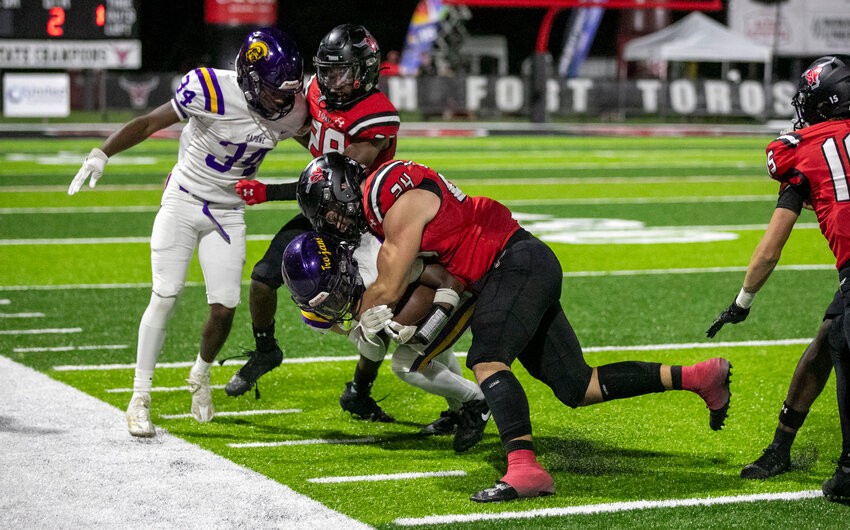 Spanish Fort senior Newton Gardner meets Daphne junior Jaecyn Myles on the sideline during the second quarter of Friday&rsquo;s non-region rivalry matchup between the Toros and Trojans on The Hill. Gardner helped spark the team with a halftime speech then delivered a blocked field goal and pick-six in the second half to help Spanish Fort secure a 21-7 win.