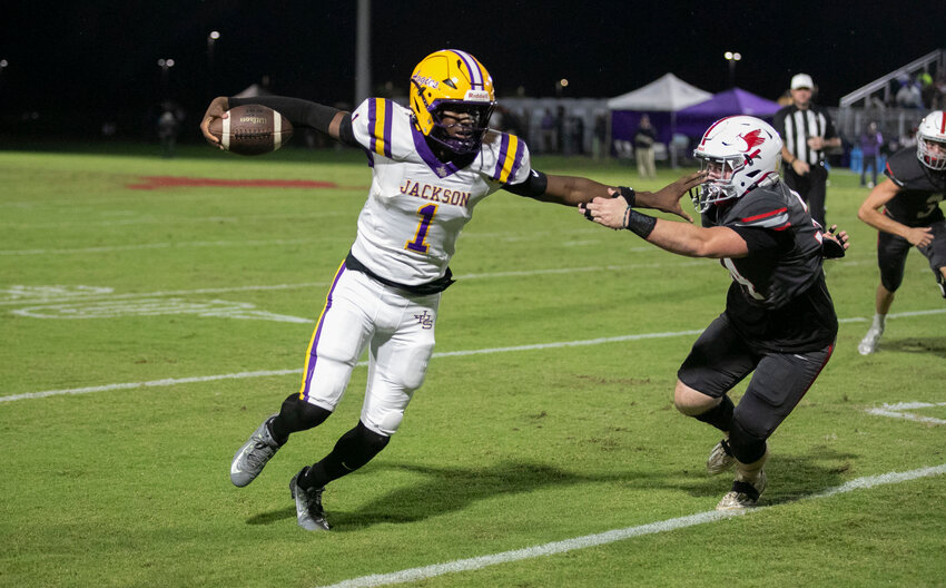 St. Michael junior Brody Jones secures a catch and turns upfield during the second half of the Cardinals’ home game against the Jackson Aggies on Friday, Oct. 4. Jones caught a first-quarter touchdown pass from sophomore Gunner Rivers to complete a 45-yard score that tied the game.